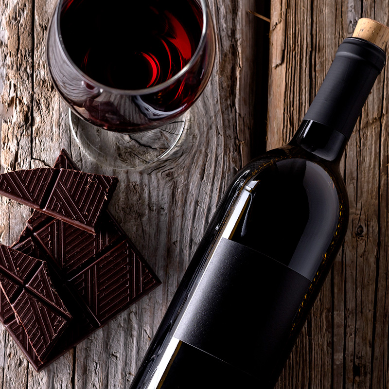 a block of dark chocolate and a glass of red wine.